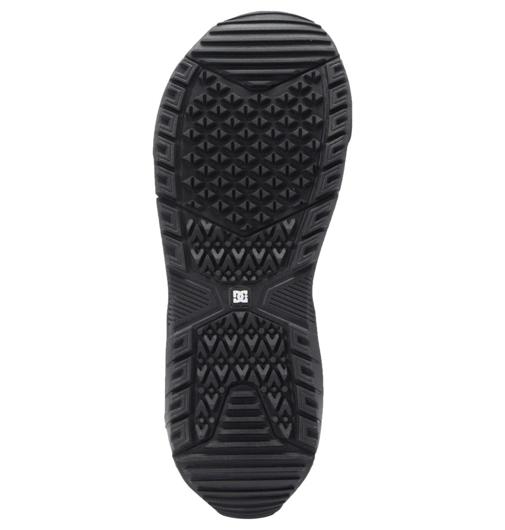 The Men's Phase Pro Step On BOA® Snowboard Boots by DC Shoes feature a black rubber sole with geometric tread patterns, ridges, textured triangles, and a central DC logo for grip and traction.