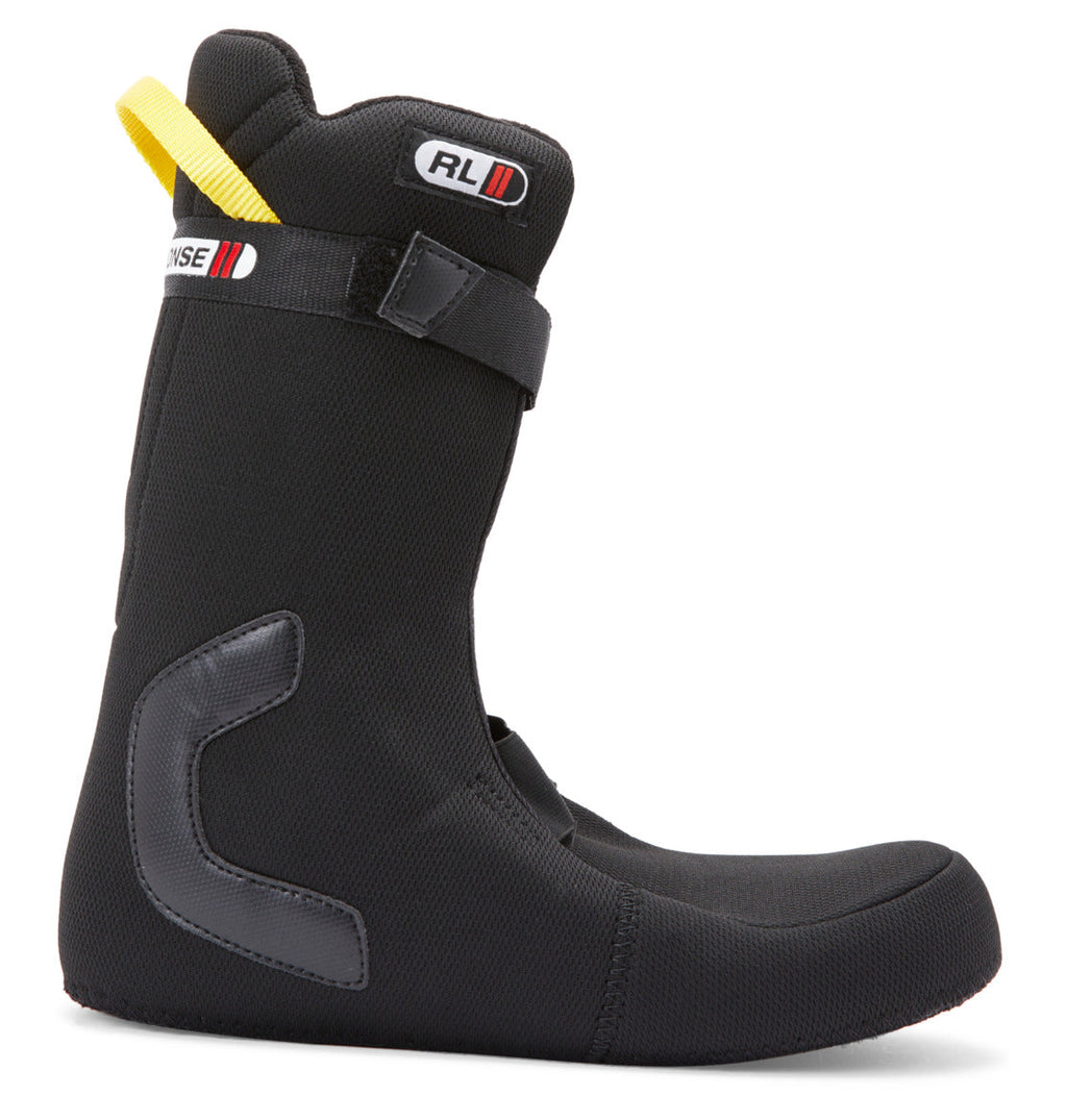 A pair of Men’s Premier Hybrid BOA® Snowboard Boots by DC Shoes in black, featuring a yellow pull tab, reinforced heel, and a Velcro strap around the upper ankle, displayed on a white background.