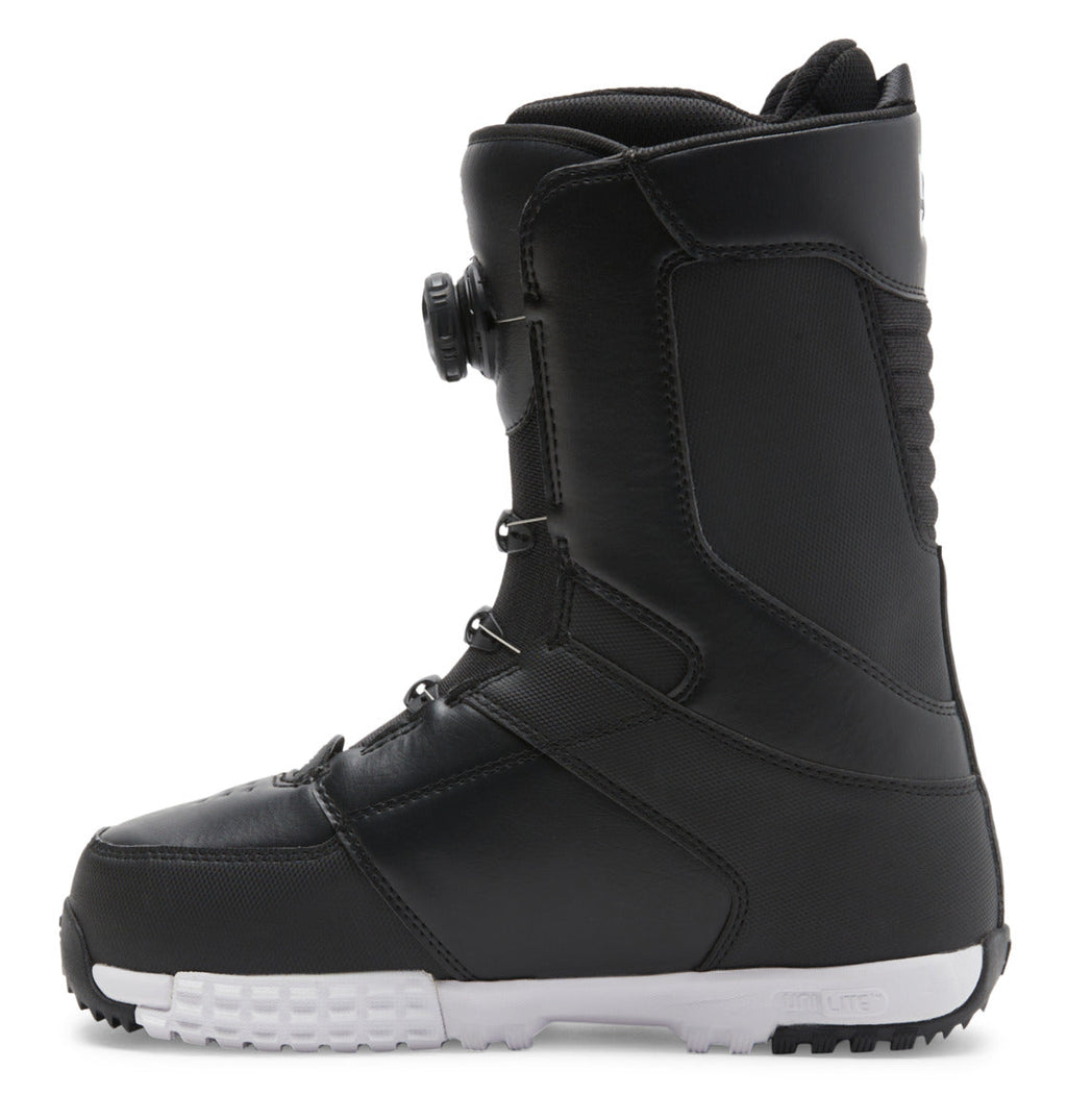 The Men’s Control BOA® Snowboard Boot by DC Shoes is shown in a left side profile against a white background. This black all-mountain boot features a contrasting white sole, thick stitching along the seams, and a side dial from the Dual Zone BOA Fit System for precision tightening.