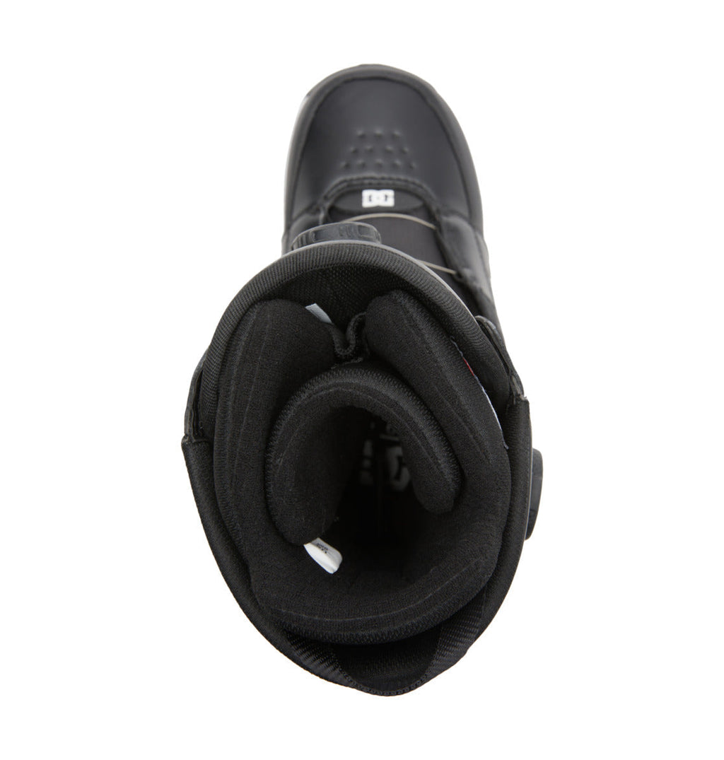 Top view of the DC Shoes Men’s Control BOA® Snowboard Boot in black, highlighting its padded interior and tongue with a DC logo on the tongue and white tags inside. Inspired by skate footwear, this all-mountain boot features the Dual Zone BOA® Fit System for precise adjustment and enhanced comfort.