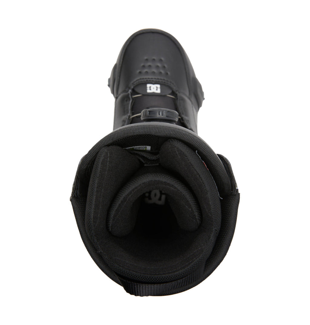 A top-down view of the Men’s Control Step On BOA® Snowboard Boots by DC Shoes showcases a black snowboarding boot with padded lining and a front buckle system, highlighting modern snow boot innovation inspired by the Dual Zone BOA® Fit System for enhanced comfort and support.
