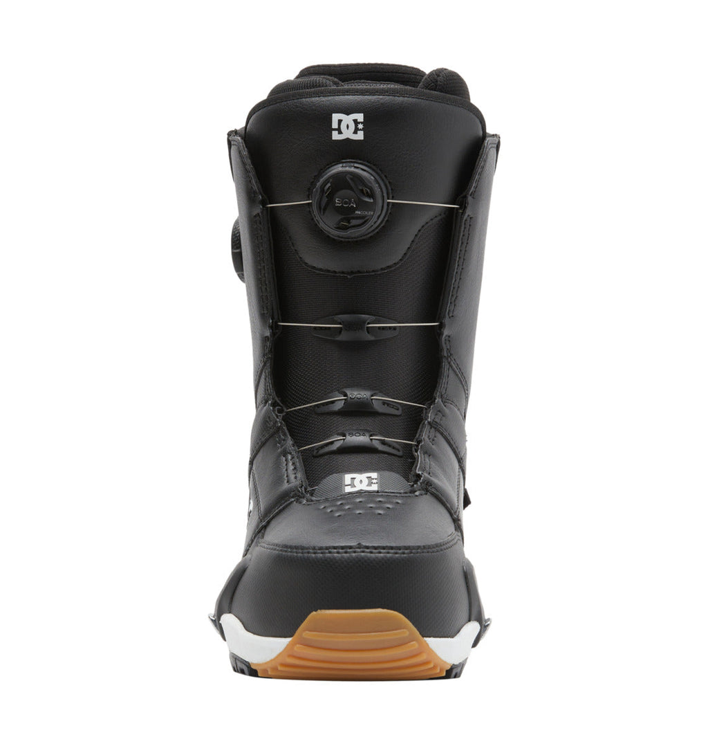 A pair of Men’s Control Step On BOA® Snowboard Boots by DC Shoes, in black, featuring the Dual Zone BOA Fit System, with the iconic DC logo displayed on the tongue and lower front, and finished with a brown rubber sole—shown facing forward against a white background as an example of snow boot innovation.