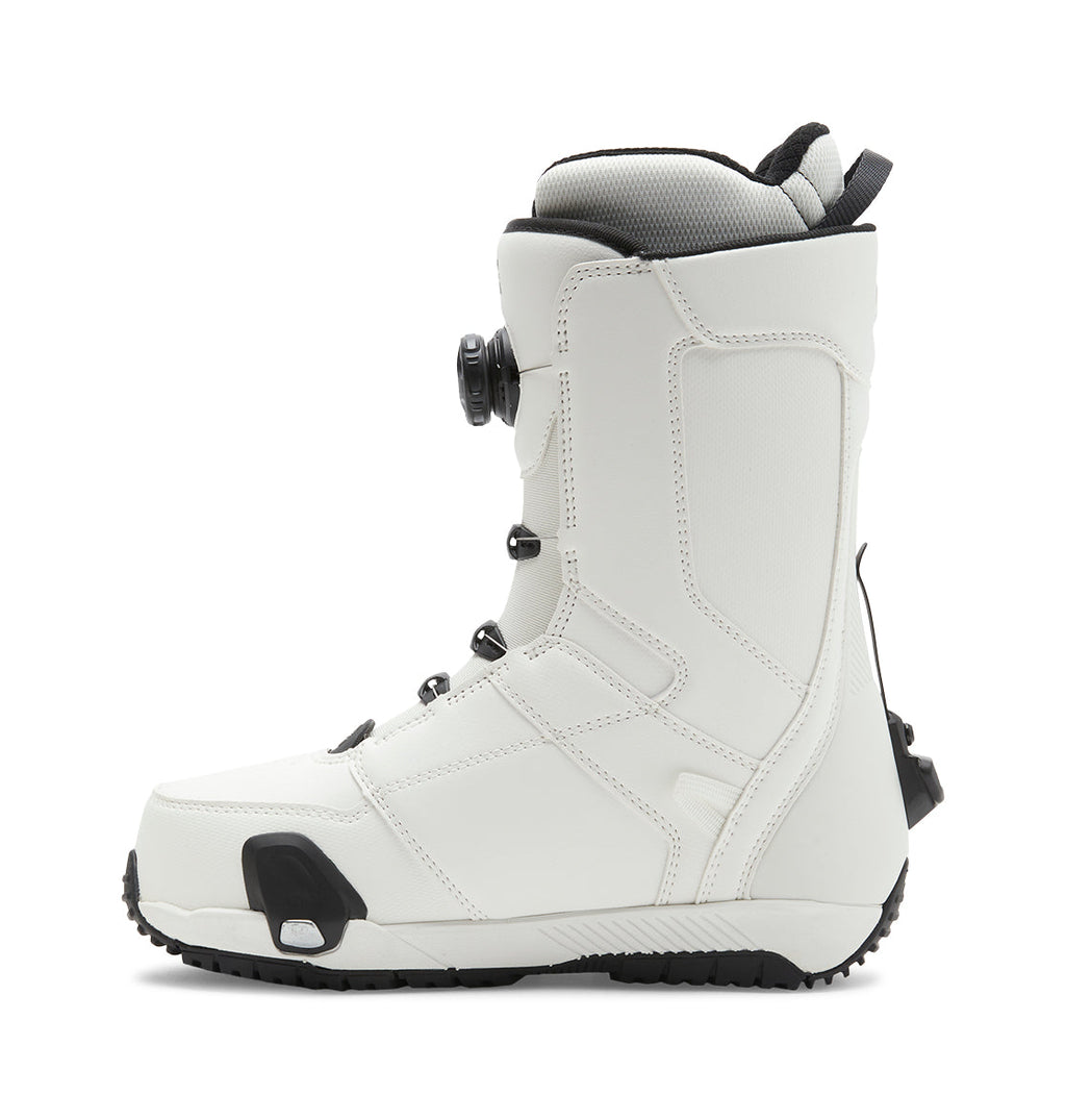 A side profile view of the DC Shoes Men’s Control Step On® Snowboard Boot in white with black accents, featuring a Dual Zone BOA Fit System for precise lacing and a textured sole, highlighting snow boot innovation, isolated on a white background.