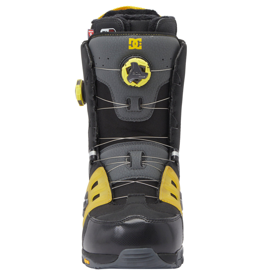 Front view of the Men’s Phantom BOA® Snowboard Boots by DC Shoes in black, gray, and yellow, showcasing the DC Shoes logo near the top. These boots are designed with a round BOA® Fit System tightening dial and exposed wire lacing on the front and side. Featuring PrimaLoft insulation for enhanced warmth, they are ideal for enduring cold mountain conditions.