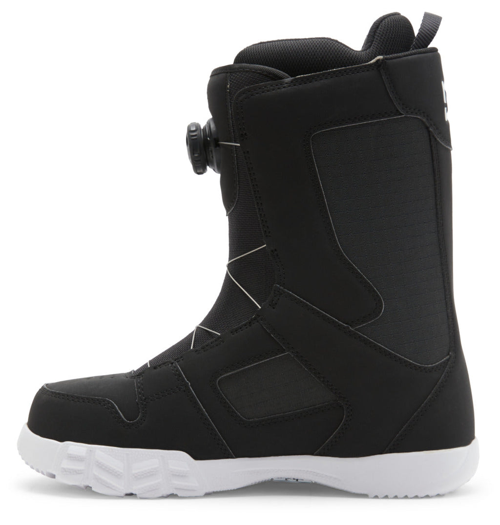 The DC Shoes Men’s Phase BOA® Snowboard Boots, shown here in black with a white sole from the side, feature the BOA Fit System for precise lacing, reinforced stitching for durability, and IMPACT-ALG insoles for enhanced comfort—making them ideal for snowboarding.