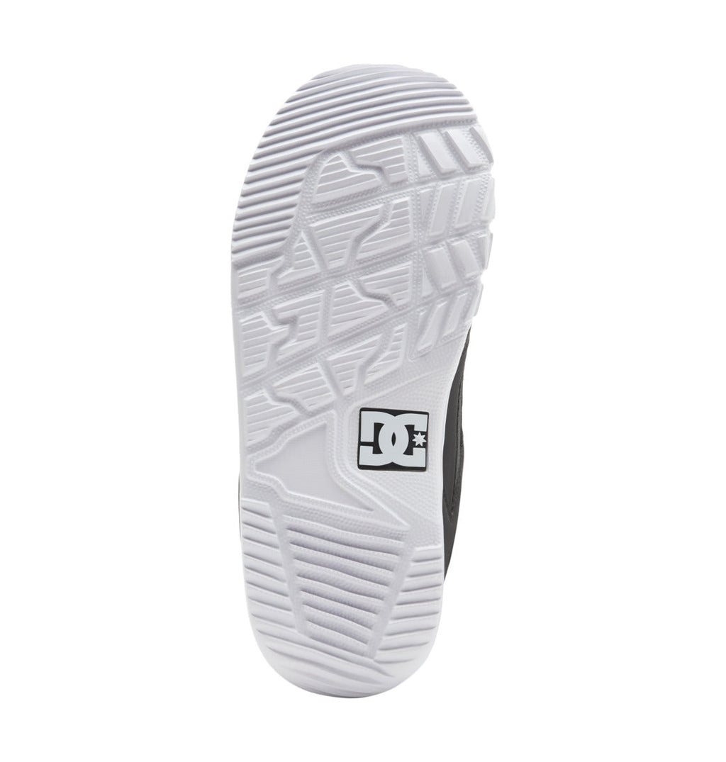 The image shows the white, textured sole of the Men’s Phase BOA® Snowboard Boots by DC Shoes, with the DC Shoes logo in black and white near the center. The tread pattern features various geometric shapes for grip, while IMPACT-ALG™ insoles deliver enhanced comfort and support.