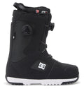 A pair of Men’s Phase Pro BOA® Snowboard Boots by DC Shoes in black with white accents, showcasing a side dial BOA® tightening system for a secure fit, PrimaLoft insulation for extra warmth, and visible DC Shoes logos on the heel and side, displayed against a white background.