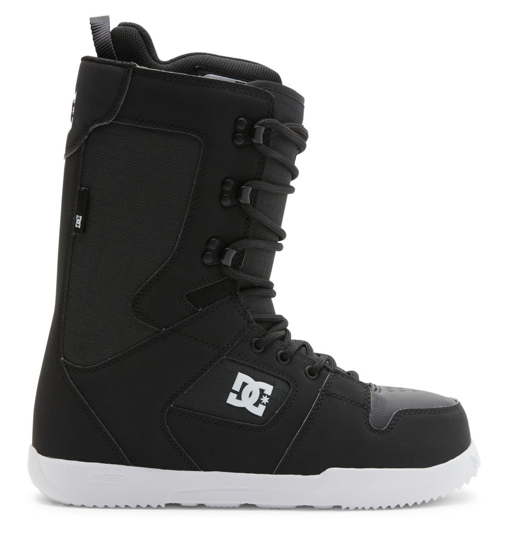 A side view of the Men’s Phase Lace Snowboard Boots by DC Shoes is shown on a white background. The boots are black with medium flex, featuring a white sole, traditional front lace closure, padded ankle support, and a DC Shoes logo on the side.