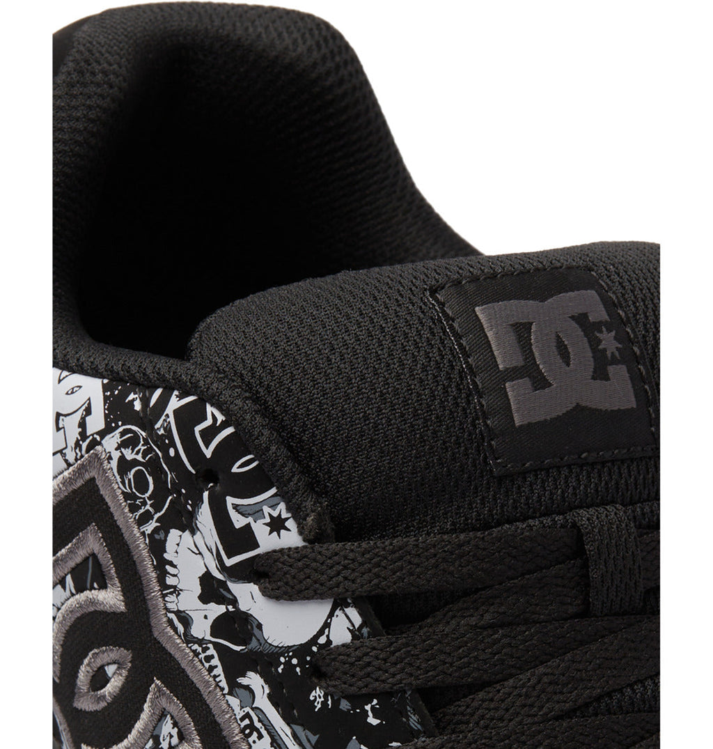 Close-up of a black Men’s Gaveler Shoe by DC Shoes, crafted from durable leather and featuring a white and black graphic design along with the iconic DC Shoes logo on the tongue and side, highlighting the signature chunky style typical of Gaveler Shoes.