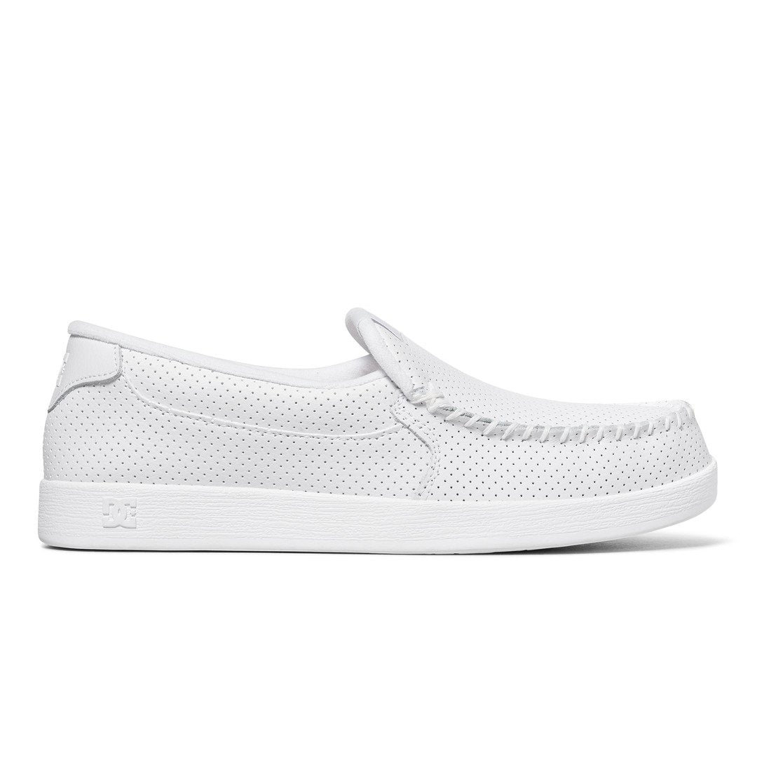 The DC Shoes Men’s Villain Slip-On Shoes are white, lightweight moccasin-style slip-ons featuring perforated detailing, visible toe stitching, and a flat sole—ideal as a casual shoe for effortless after-skate comfort.