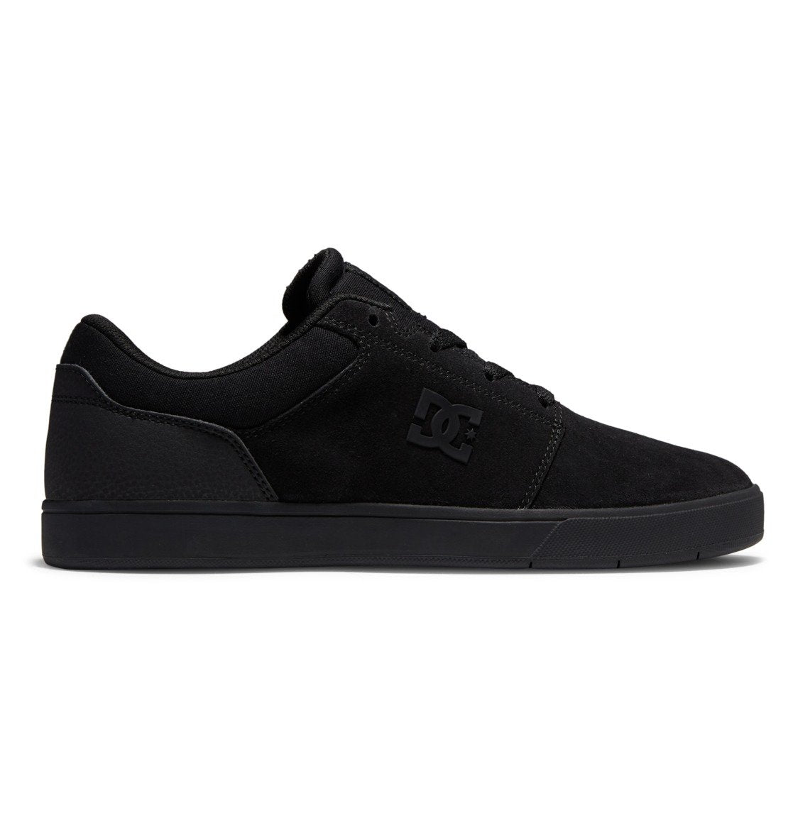 A side profile of the Men’s Crisis 2 Shoes by DC Shoes is shown in black, featuring a low-top silhouette, a performance cup sole, and subtle branding on the side, photographed against a white background.