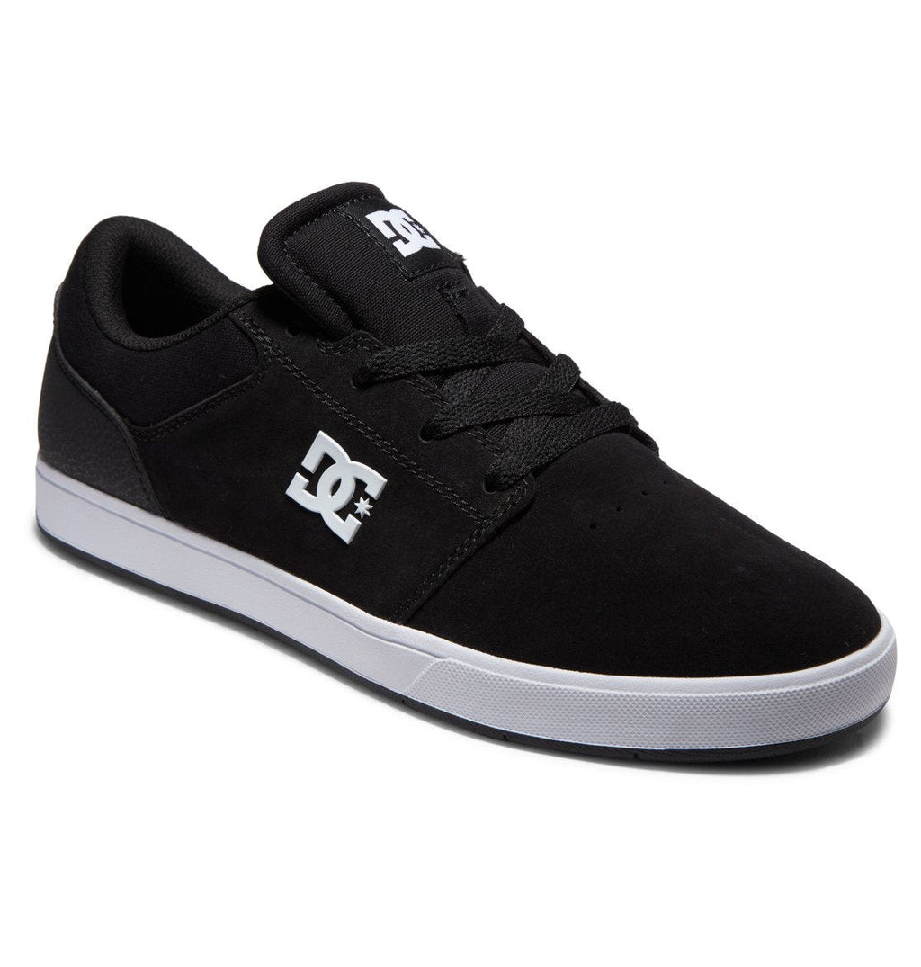 The Men’s Crisis 2 Shoes by DC Shoes are black skate shoes featuring black laces, a performance cup sole, and a bold white DC logo on the side and tongue. Their modern design is showcased against a white background.