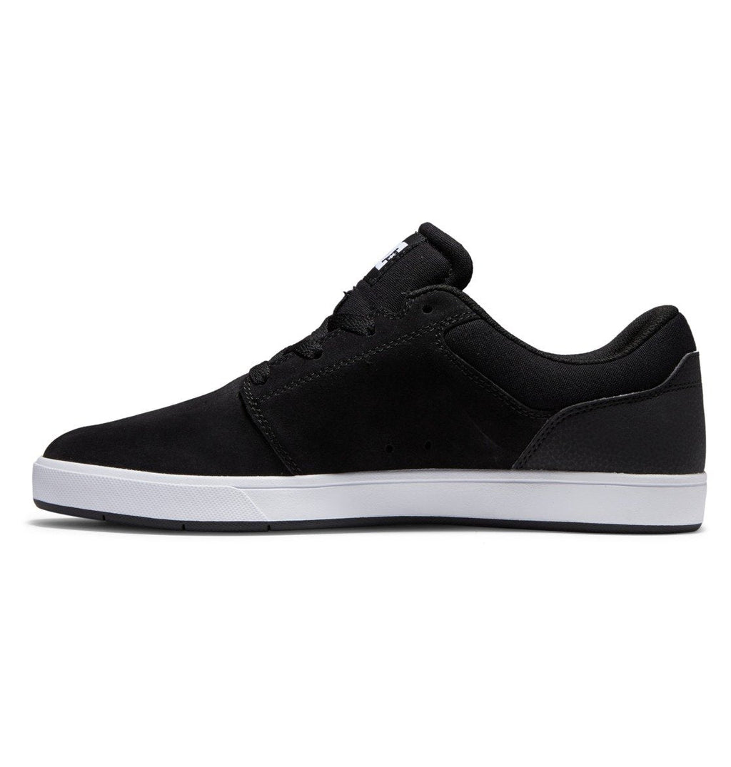 The Men’s Crisis 2 Shoes by DC Shoes are displayed in a left side profile view against a plain white background. This black low-top sneaker with a white sole showcases a performance cup sole for enhanced support, delivering a modern look and making it an ideal choice for those seeking affordable skate shoes.