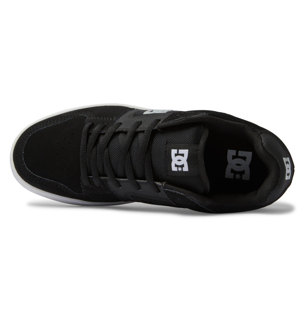 Top view of the Men’s Manteca 4 Shoes by DC Shoes in black, featuring black laces, a white DC logo on the tongue, and a white sole edge visible at the toe and sides—highlighting the Manteca 4’s performance-focused design.