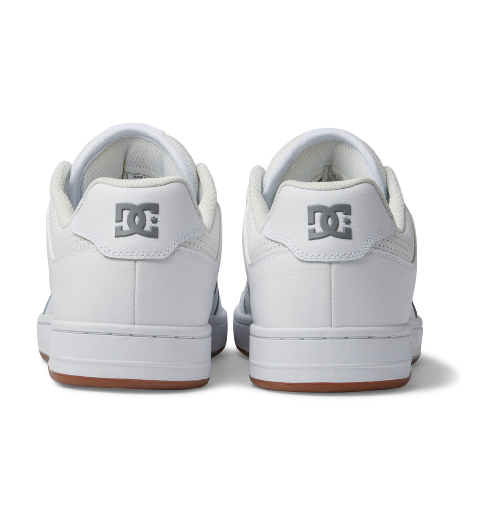 Back view of the Men’s Manteca 4 Shoes by DC Shoes in white with gray DC logos on the heels, white midsoles, and light brown outsoles, set against a plain white background.
