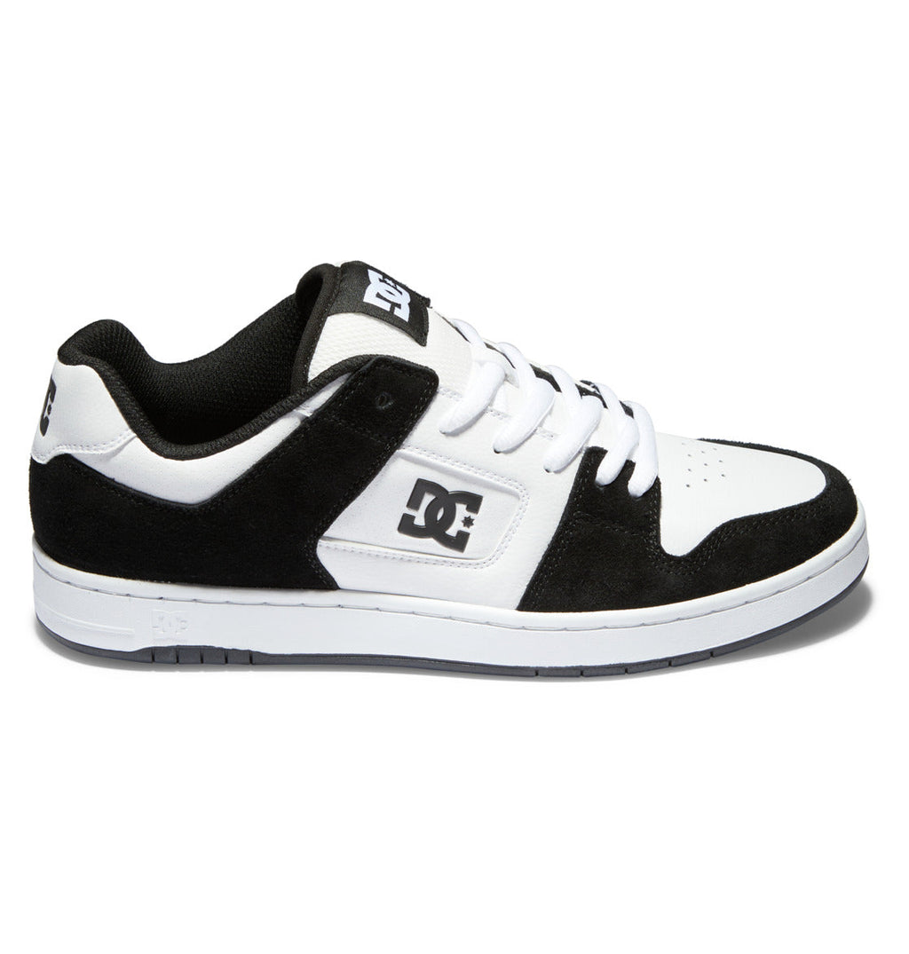 The Men’s Manteca 4 Shoes from DC Shoes feature a classic black and white design with a white sole, black suede accents, white laces, and the iconic DC logo on both the side and tongue, offering modern comfort for skateboarding and everyday wear.