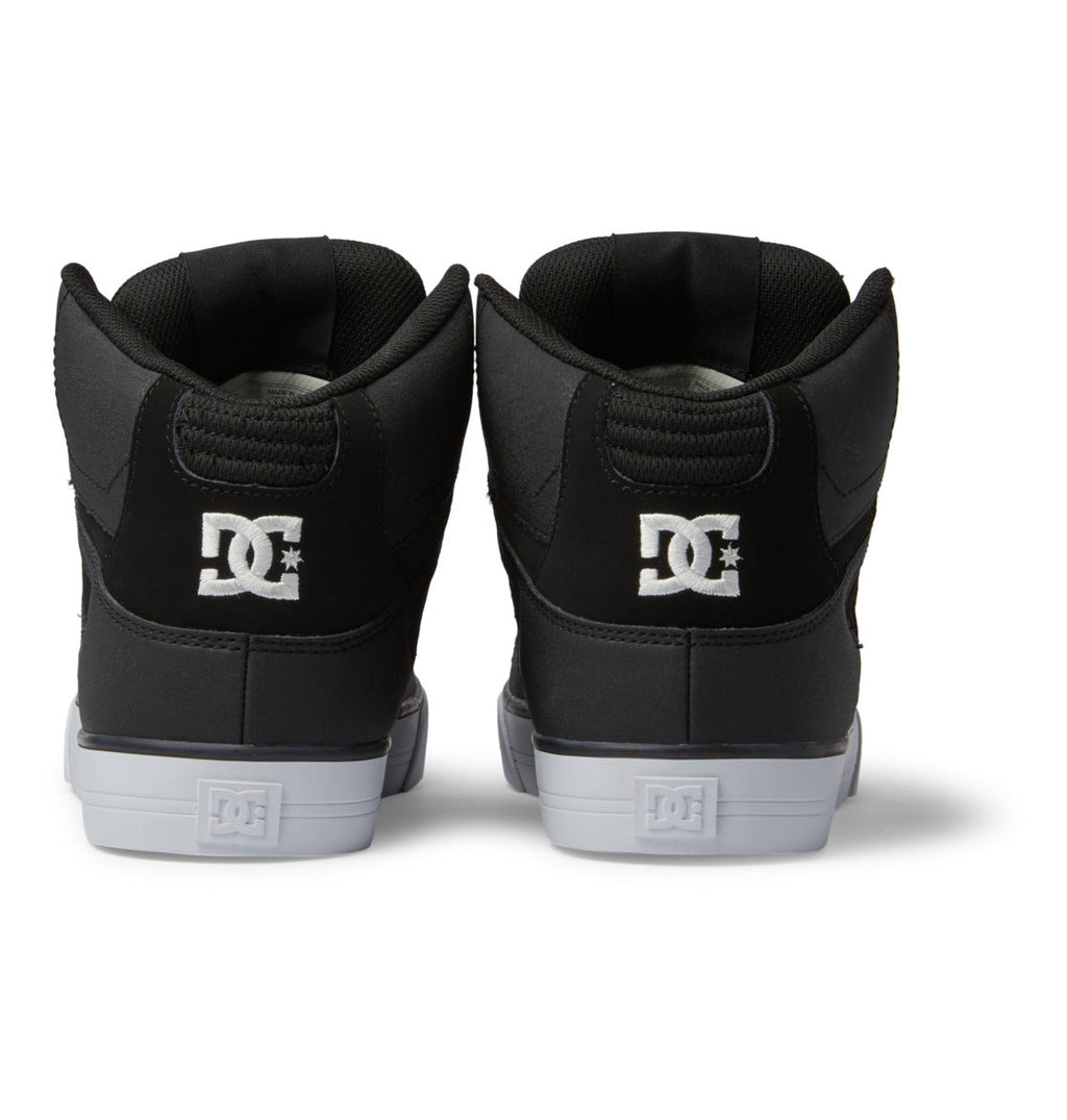 Rear view of a pair of DC Shoes Men’s Pure High-Top Shoes in black, featuring a white embroidered DC logo on the heel and white rubber soles—combining durability and comfort in a stylish design—displayed against a white background.