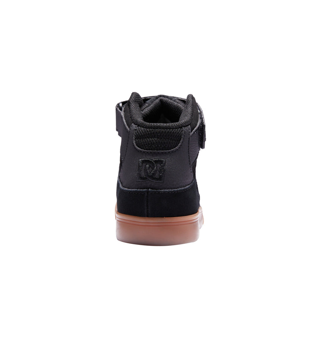 Rear view of the Men’s DC Pure High-Top Shoes by DC Shoes in black leather, inspired by classic skate shoe designs, displaying a DC logo on the heel and set on a brown rubber sole, photographed against a white background.
