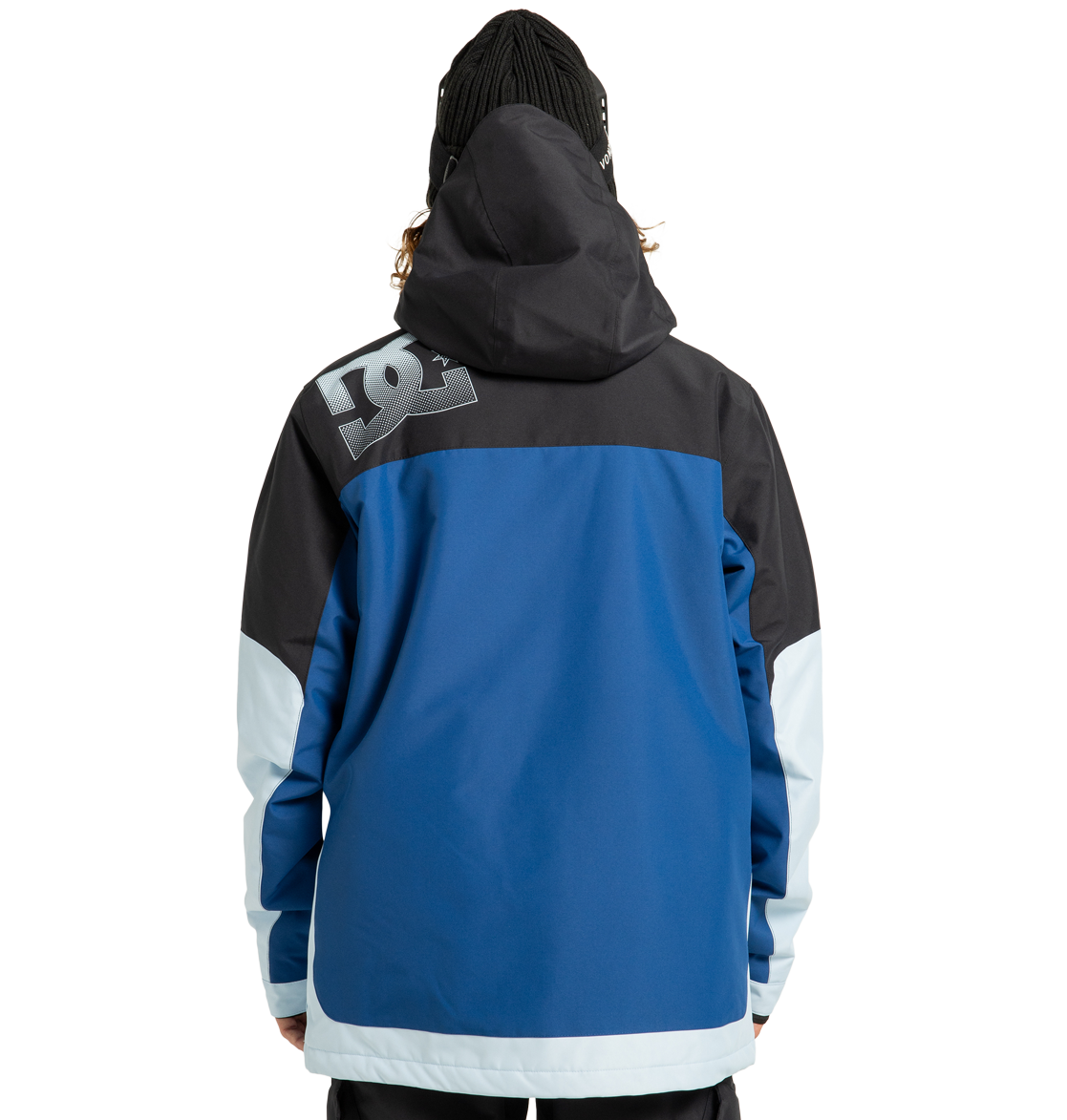 A person, seen from behind, wears the Men’s Defiant Insulated Jacket by DC Shoes—a hooded, insulated jacket in blue, black, and light blue recycled polyester with the DC Shoes logo on the upper back. The individual also has on a black beanie. The background is plain white.