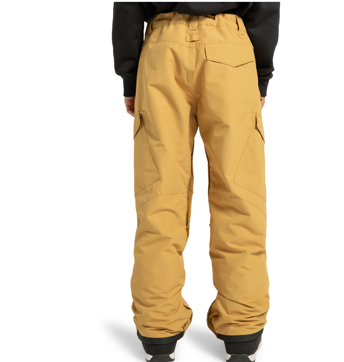 A person is shown from the back, standing against a plain white background with hands by their sides, wearing loose-fitting tan Men’s Banshee Insulated Pants from DC Shoes—crafted from recycled polyester—and a black sweatshirt.