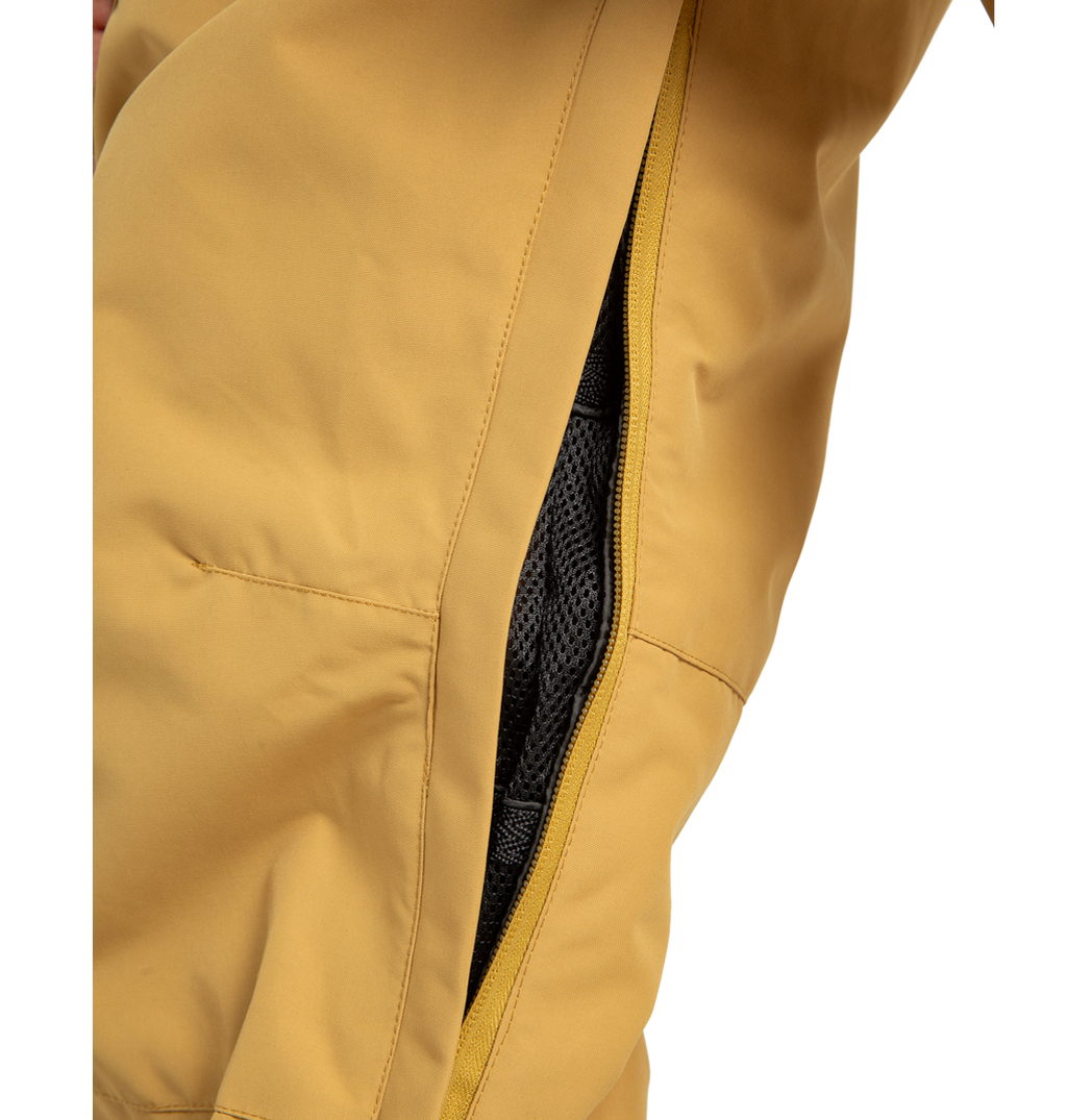 Close-up of DC Shoes Men’s Banshee Insulated Pants in yellow, showing a partially unzipped side vent that reveals black mesh lining made from recycled polyester.