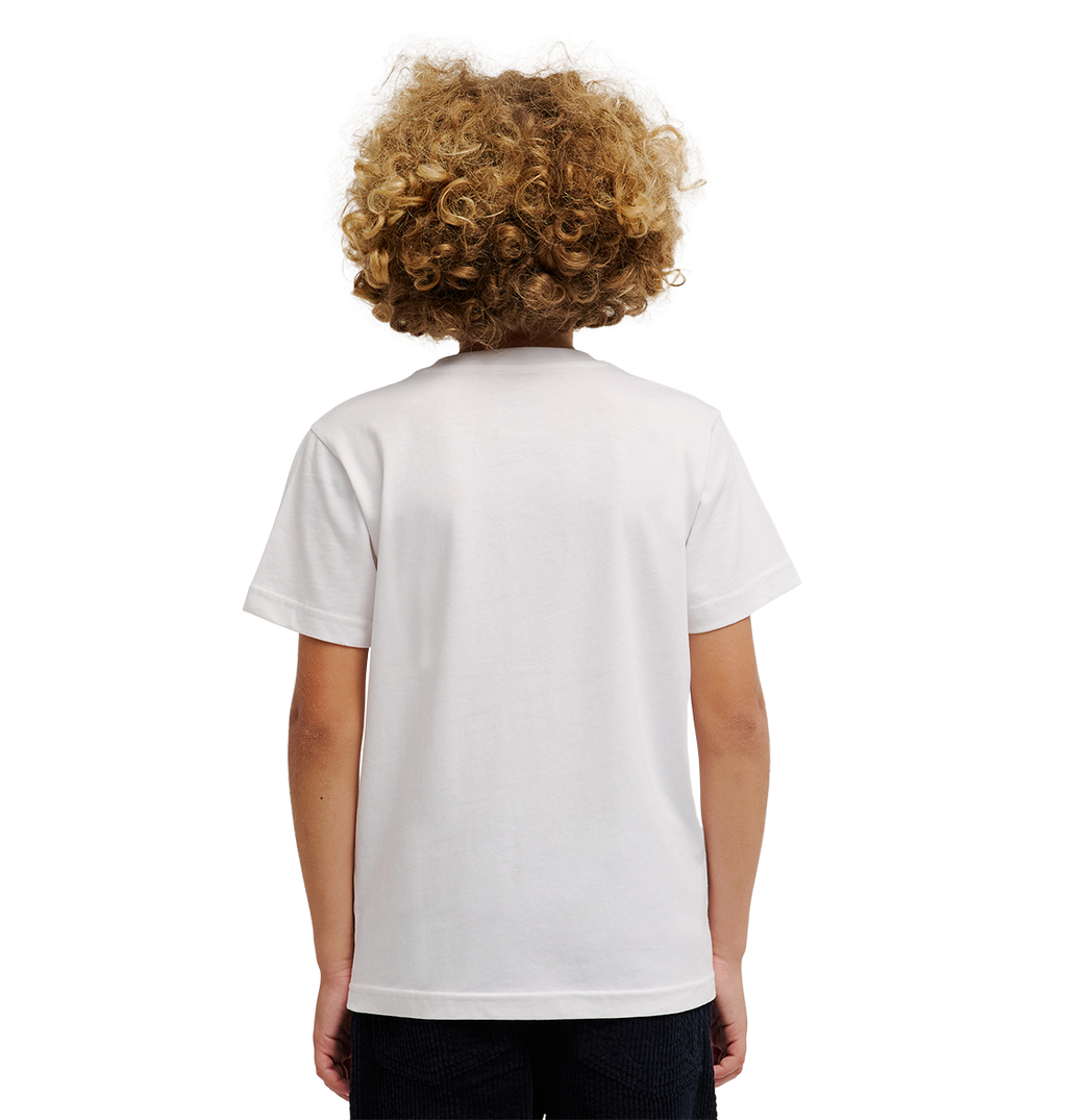 A child with curly blond hair stands facing away from the camera against a white background, wearing the DC Shoes DC Side Flame Tee Youth—a relaxed-fit graphic skate t-shirt featuring subtle flame artwork.