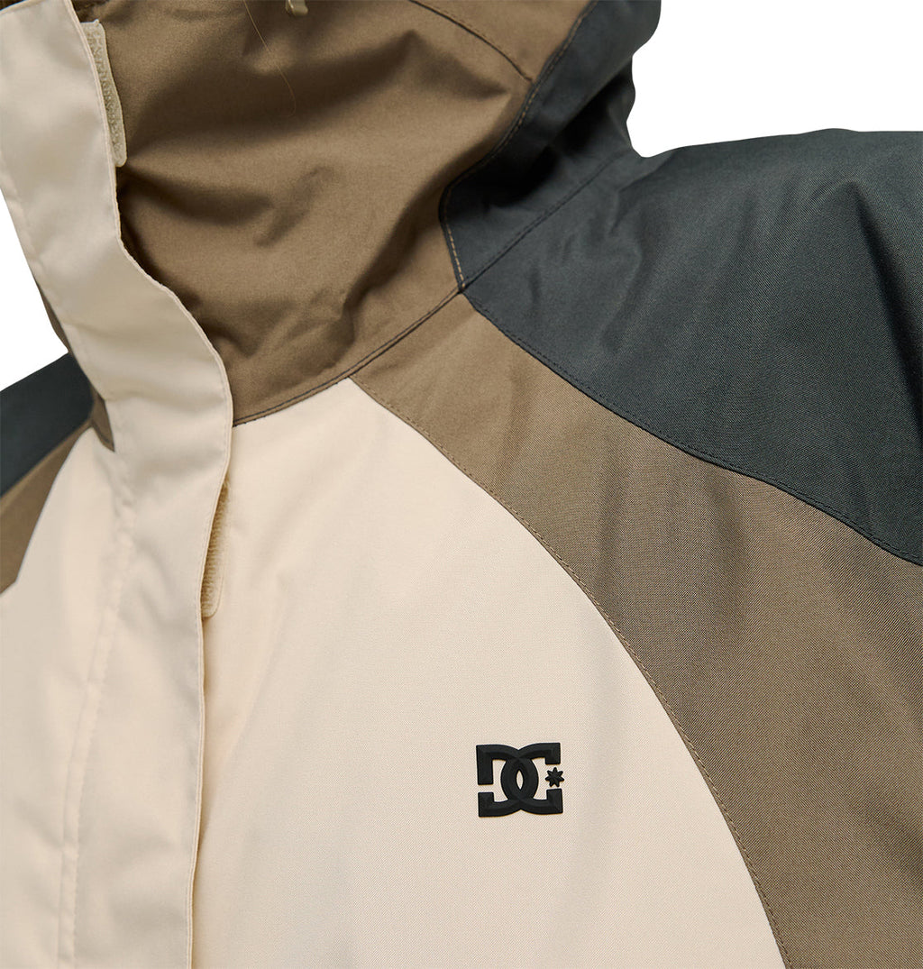 Close-up of the Everfrost Jacket by DC Shoes in beige and brown, featuring the black DC Shoes logo on the chest and showing part of the collar and shoulder.