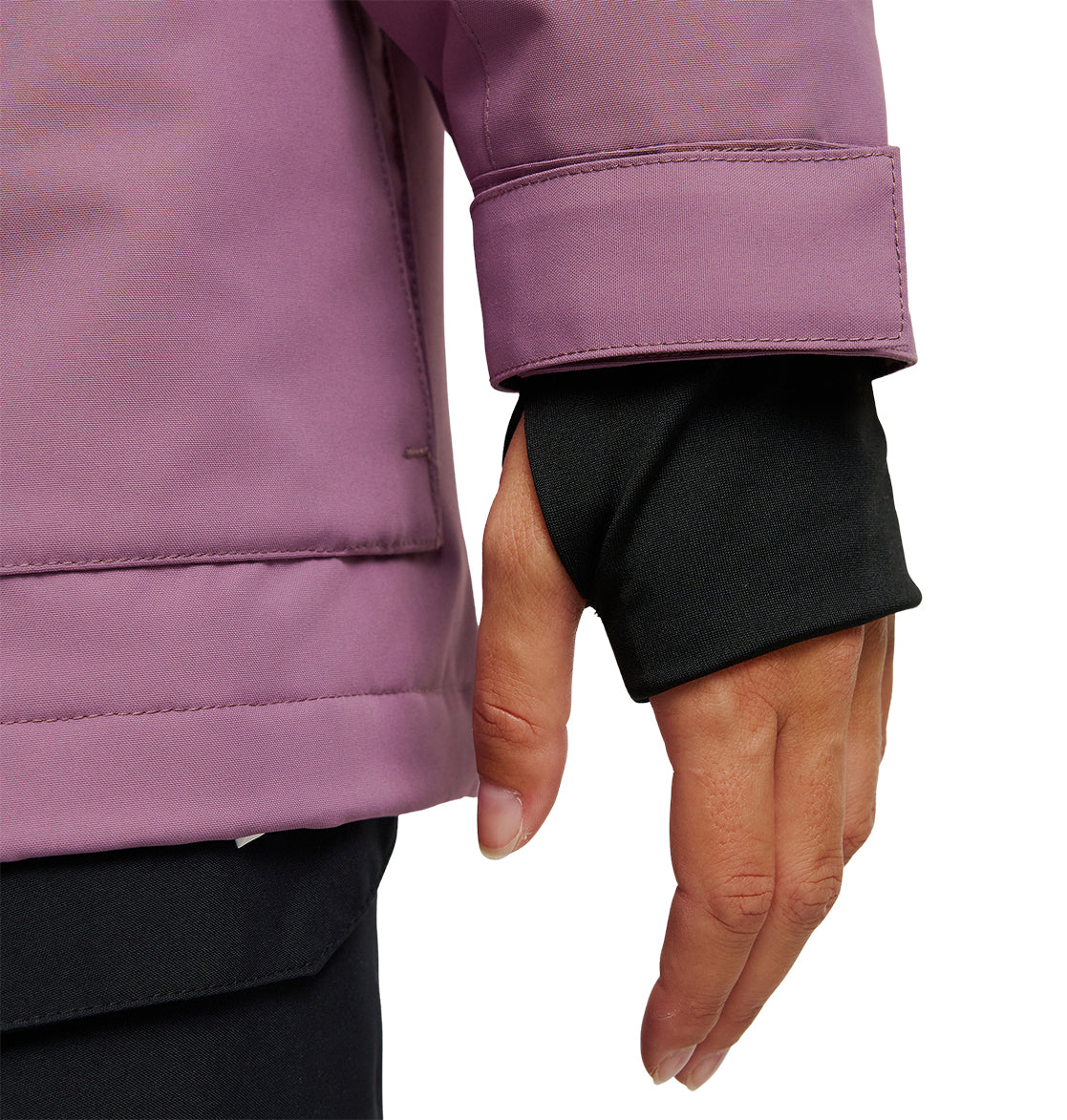 A close-up of a person’s hand wearing a black glove beneath the cuff of a purple DC Shoes Cruiser Jacket. The jacket sleeve features a velcro wrist strap, emphasizing its warm and protective design.