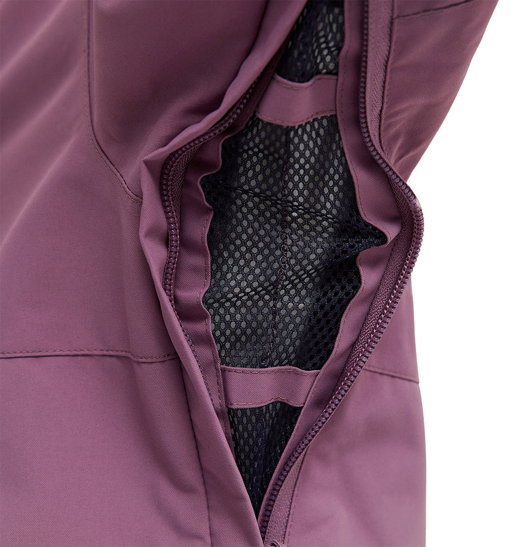 Close-up of a purple Cruiser Jacket by DC Shoes, featuring a partially unzipped pocket that reveals black mesh lining inside—engineered for snow performance and built as a reliable waterproof jacket.