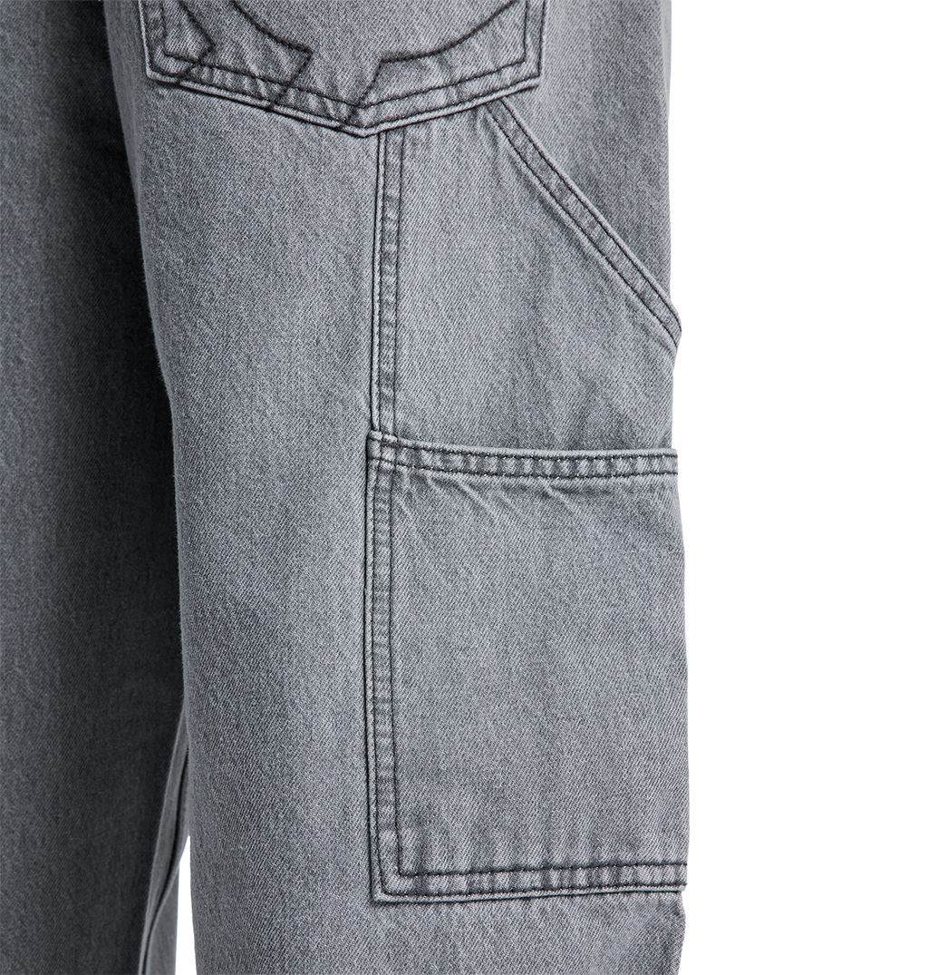Close-up of the DC Shoes Men's Baggy Denim Carpenter Pant in gray, showing a large rectangular side pocket with visible stitching and part of another pocket above it, highlighting the signature baggy carpenter jeans style.