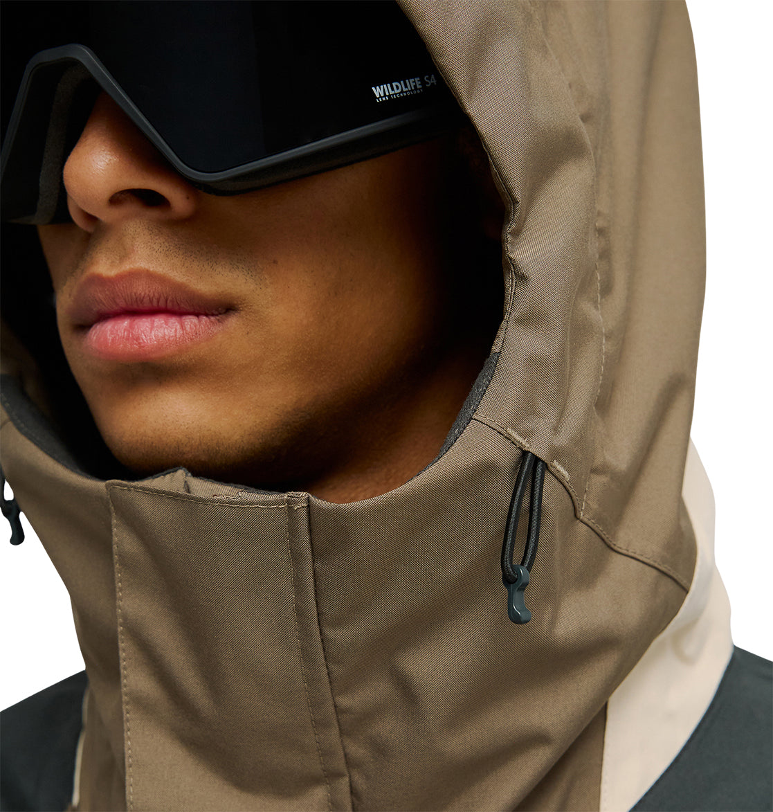 Wearing the DC Shoes Coldsmoke Jacket 10K with the hood cinched snugly around their face, the person’s lower face is visible beneath large black sunglasses—showcasing the jacket’s breathable cold-weather protection up close.
