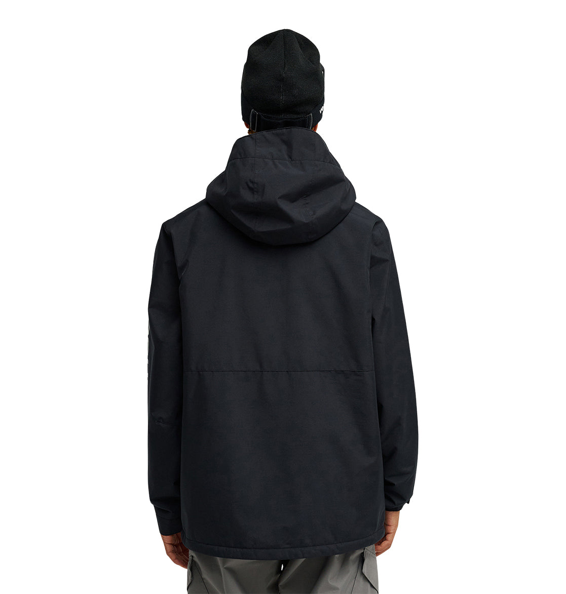 A person is shown from the back, wearing the DC Shoes Basis Jacket 10K in black with a hood and a black beanie, standing against a plain white background.