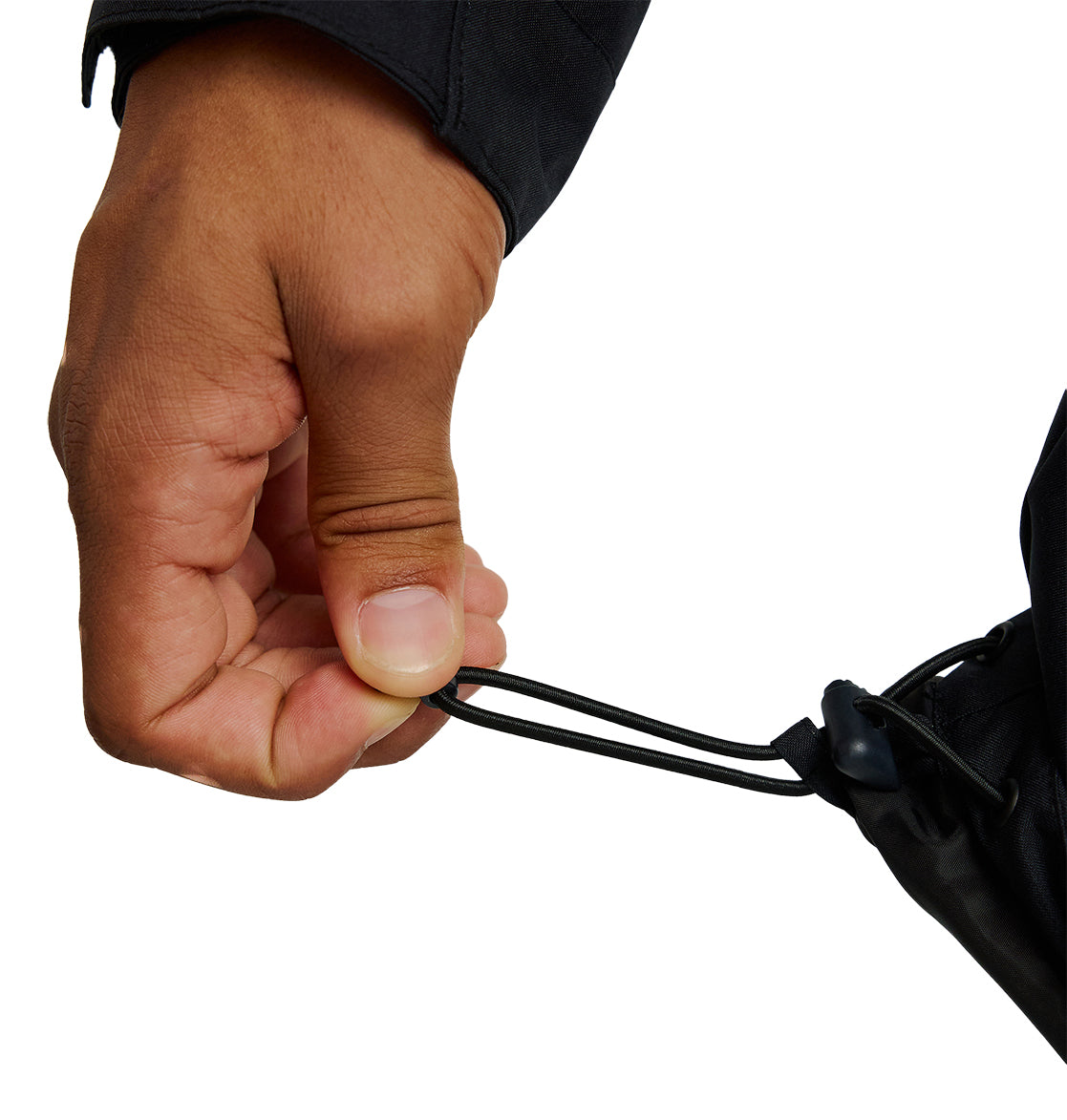 A close-up of a hand adjusting the drawstring cord at the hem of the black DC Shoes Basis Jacket 10K insulated sleeve.