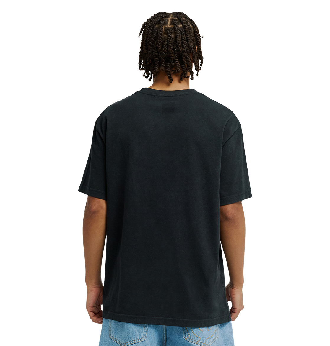 A person with short, twisted braids is shown from behind, wearing a relaxed fit black Men's DC Star Struck Tee by DC Shoes and light blue denim shorts against a plain white background.