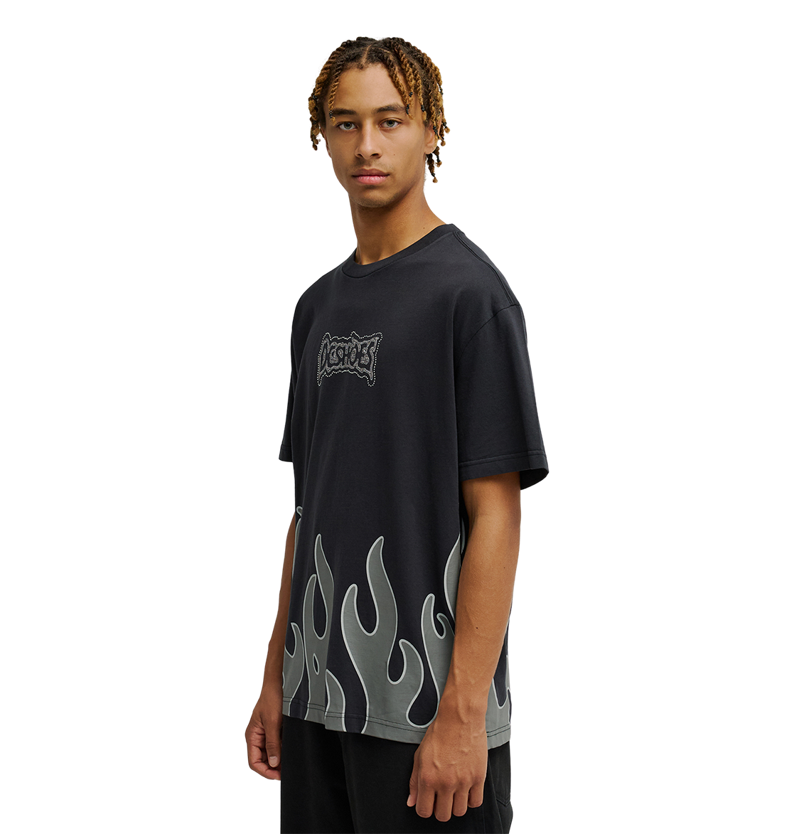 A person with short braided hair wears the Men's DC Burning Diamonds Tee by DC Shoes—a black graphic skate T-shirt with gray flame designs on the lower half and a small decorative logo on the chest—while standing against a plain white background.