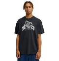 A person with braided hair wears the Men's DC Speratic Tee by DC Shoes—a relaxed fit black graphic skate t-shirt with a bold white logo—paired with blue jeans, standing against a plain white background.